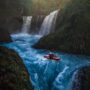 person-on-watercraft-near-waterfall-1761282